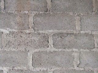 Poster - Closeup shot of the wall made up of gray rectangular stones and concrete