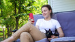 © Parten - Smiling young woman relax sit on sofa with black pet cat on home terrace,using phone texting chat with friend.Happy brunette girl on couch hold smartphone shop online,check application,social media
