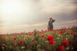 © Ирина Ваганова - mom and daughter on a poppy field in the rays of the setting sun