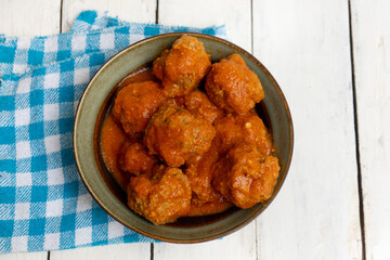 Wall Mural - Meatballs in red sauce on white background