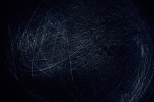 White Scratches On A Black Background. Dark Background With A Blue Tint. Abstract Scratches Background.
