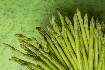 Fresh asparagus on a green background close-up