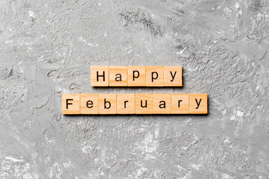 Happy February word written on wood block. Happy February text on table, concept