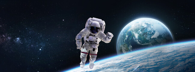 Astronaut in the outer space near Earth planet surface. Abstract wallpaper. Spaceman. Elements of this image furnished by NASA