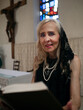 © Magdalena Juillard - Mature woman reading the Holy Bible in a church