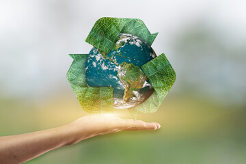 Canvas Print - hand holding planet earth and recycle icon over blur green background. elements of this image are fu