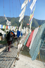 Wall Mural - Prayer flags protect suspension bridge