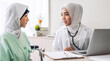 © Art_Photo - Muslim asian woman doctor service help support discussing and consulting talk to muslim woman patient and check up information at meeting health medical care express trust concept in hospital