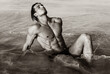 © PKpix - Sexy fit male model with hot strong body lying in the water at the beach.