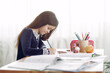 © prostooleh - Child with a books. Girl sitting on a table. Kid in a class.
