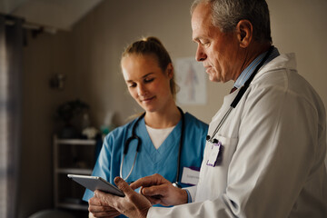 Discussion between Male and female Doctors on digital tablet