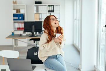 Wall Mural - Young woman taking a break in the office