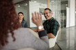 © JonoErasmus - Mature businessman laughing while talking with colleagues at workers