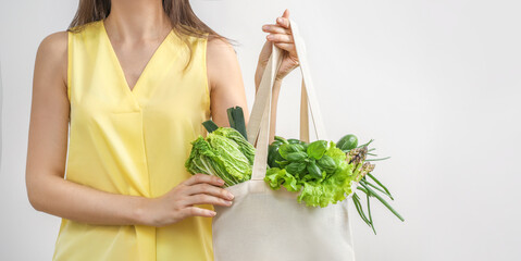 Wall Mural - Woman with fresh vegetables in eco bag