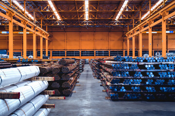 Pack of steel round bar stack in layer inside large distribution warehouse. Steel warehouse logistics operations.