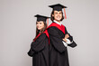 © F8  \ Suport Ukraine - Portrait of two happy graduating students isolated over white background.