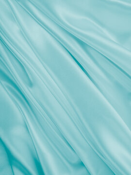Wall Mural - Beautiful elegant wavy turquoise silk or satin luxury cloth fabric texture, abstract background design.