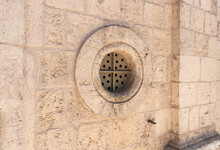 The Round Stone Window With Iron Bars In The Wall Of The Deir Al-Mukhraqa Carmelite Monastery In Northern Israel