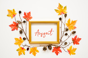 Wall Mural - golden frame with german text auszeit means downtime. beautiful, colorful autumn leaf decoration wit