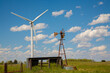 © Bob - New and old windmills. A new power generating windmill and an old windmill powering a water pump supplying water for cattle