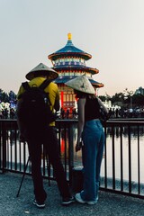 Poster - Vertical shot of a couple standing near an oriental building