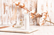 © romanovad - Mockup of face cream bottle on a marble tray and wooden table. Cosmetic or spa skincare concept, cotton branch