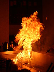 Japanese Teppanyaki Fire. Flame on Teppanyaki Grill. 
Japanese Chef is cooking beef on an open flame grill.