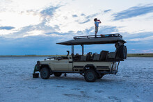Six Year Old Boy And Older Sister Standing On Top Of Safari Vehicle, Nxai Pan, Botswana