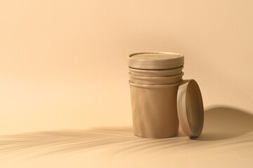 Craft paper soup cup on brown background. Container for take away food. Ecological individual package. Zero Waste.