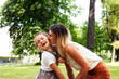 © iordani - young pretty mother walking with little cute daughter outside in green park, lifestyle poeple concept