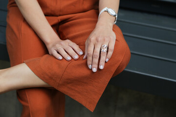 A watch accessory combination of ring boots and orange pants.