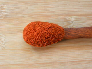 Wall Mural - Red color Chili powder on wooden spoon