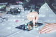 © peshkova - Double exposure of man's hand holding and using a digital device and data theme drawing. Technology concept.