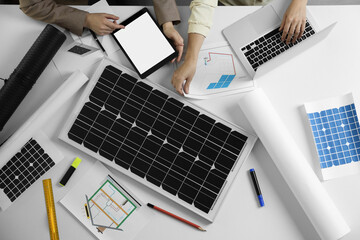 Architects working on house project with solar panels at white table, top view. Alternative energy source