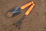 Fototapeta  - Gardening Tools On Background Of Soil Ground Top View.