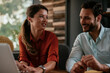 © JustLife - Colleagues in office. Businesswoman and businessman discussing work in office. Two friends in working together.