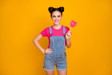 Sticker - Portrait of her she nice attractive pretty charming cute lovely cheerful cheery girl eating tasty heart candy isolated on bright vivid shine vibrant yellow color background