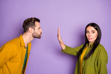 Wall Mural - Profile photo of lady guy couple boyfriend wait contact want kissing responsible girlfriend stop him raise arm keep distance terrified wear colorful shirts isolated purple color background