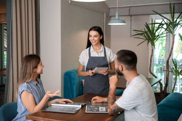 Canvas Print - Waitress serving clients in restaurant