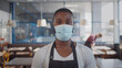 © TommyStockProject - Portrait of afro-american waiter wearing protective mask looking at camera