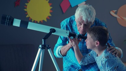 grandfather teaching grandson using telescope to see planets and galaxy. child watching stars throug