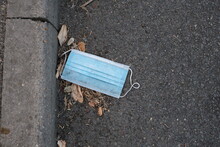 A Disposable Face Mask Discarded In The Gutter During The COVID19 Pandemic.