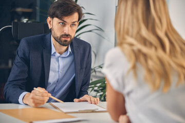 Bearded young man discussing project with business colleague