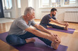 © Svitlana - Beginner yogi and his coach practicing yoga