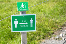 Sign Along A Path Remembering People To Stay Two Metres Apart In A Park In Iceland During The Covid-19 Pandemic
