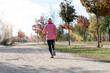 © 2Design - Rear view of a senior man in sport clothes jogging in the park in a sunny day