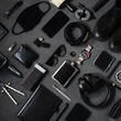 Photo topview flat lay modern style of men every day carry stuff accessories headphones camera facial mask bracelet lighter purse sunglasses tablet camera phone boots leather belt on dark background

