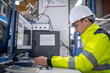 © reewungjunerr - Asian electric engineer holding clipboard for checking and monitoring the electrical system in the control room,Technician thailand people working