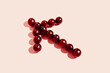 © Gustavo Pozo/ADDICTIVE STOCK - Top view of red grapes arranged in arrow showing direction on pink background
