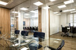 © Kavi Sanchez/ADDICTIVE STOCK - Interior of modern office with table and chairs located in room with glass walls